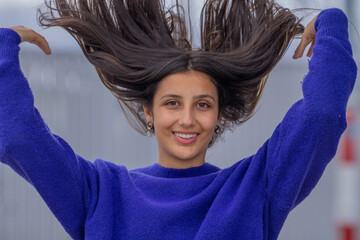 free latin girl with arms raised outside