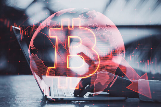 Close up of businessman hands using laptop and cellphone with falling global red bitcoin hologram on blurry outdoor background. Cryptocurrency, market fall and stock exchange concept. Double exposure.