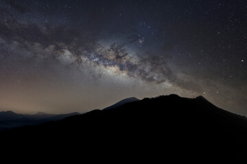 Fototapeta na wymiar panorama mountain silhouette and blue night sky milky way and star on dark background. universe called,nebula and galaxy with noise and grain. Cassiopeia is a constellation in the northern sky. 