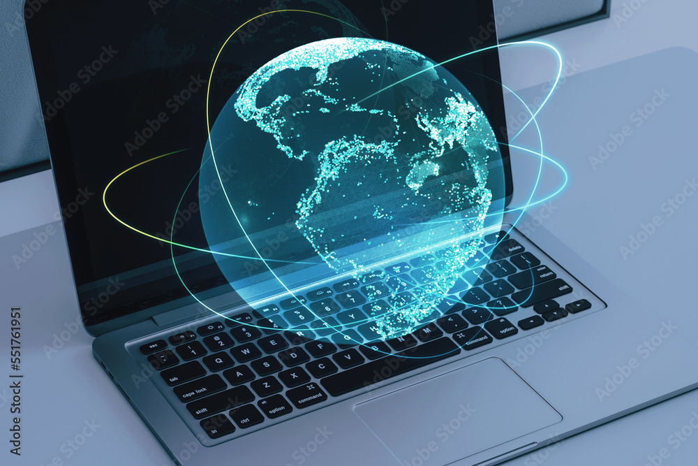 Poster close up of notebook on desktop with creative glowing globe hologram on blurry background. technolog