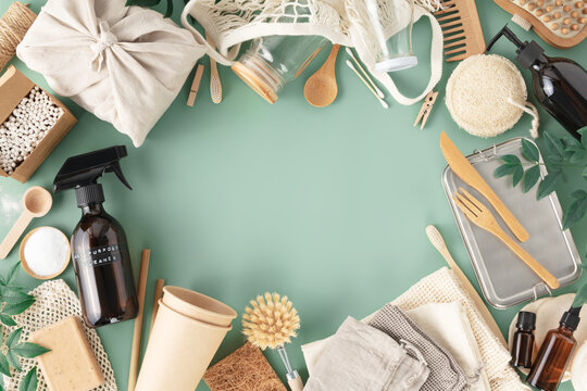 Set of eco-friendly tableware and cleaning products on pastel blue background, flat lay stop plastic pollution