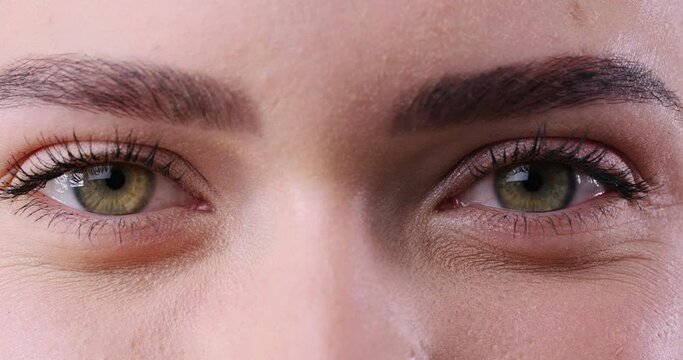 Happy young woman with beautiful eyes looking at camera, closeup view