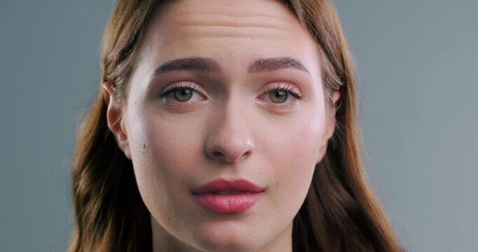 Beautiful woman rolling eyes on light grey background, closeup