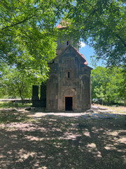 Fototapeta na wymiar Small little monastery between trees in Armenia