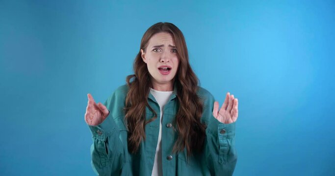 Shocked woman getting scared on light blue background