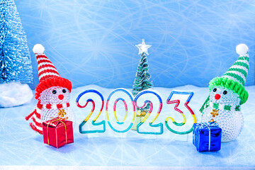 New year 2023. Christmas. two snowmen with gifts and numbers 2023. christmas background.