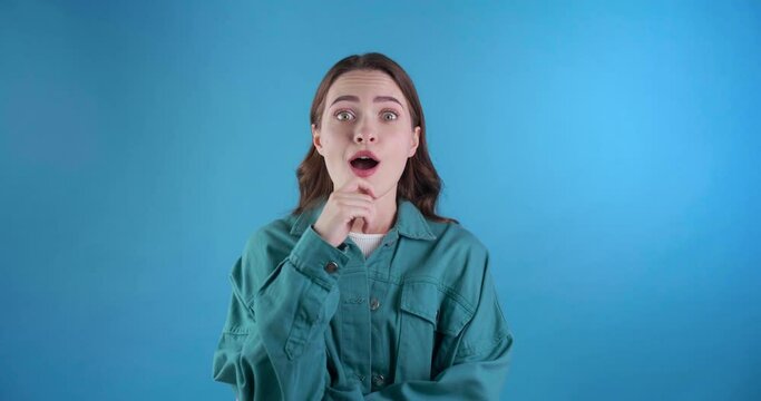 Puzzled young woman thinking about something and came up with solution. Got idea. Light blue background