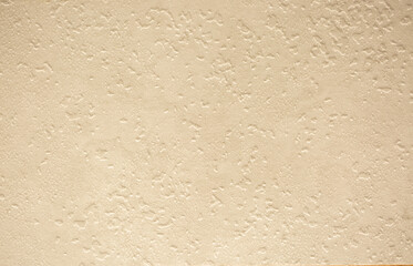 Brown background from decorative plaster with abstract spots. Unusual beige wall texture with beautiful patterns, creative surface background. Front covering for facing of buildings.