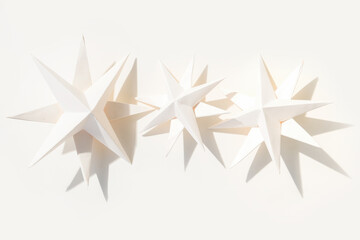 Merry Christmas.Christmas stars handmade light beige background.Monochrome,Christmas background,holiday card.DIY christmas flat lay copy space.Christmas zero waste, paper, eco postcard