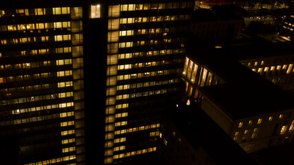 Aerial night view of an office building. The lights are on.