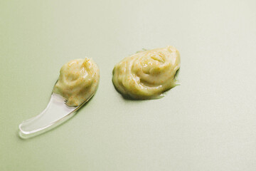 Natural cosmetics pastel green background, face body scrub, cream mask, texture sample