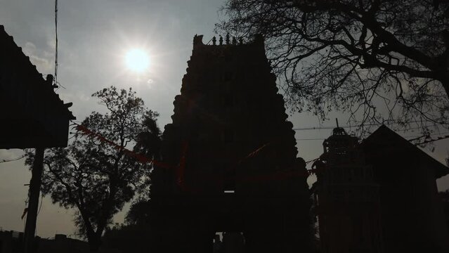Point of view shining sun over dark ancient temple at kolar