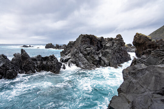 Rough sea with black volcanic rock in São Jorge, Azores