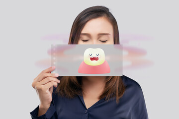 Asian female in blue wear have bad breath. Halitosis