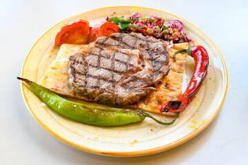 Beef steak grill with rice pilaf, fried potatoes, grilled pepper and tomatoes.Mix Platter with Beef rips, Cutlets, Potatoes and Sauces.