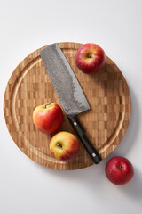 Apple on cutting board with knife
