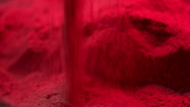 Red sand dropping on ground