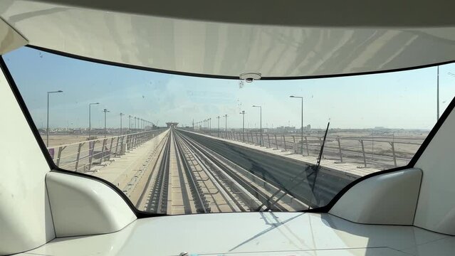 Metro train window front back railway man drive conductor in a sunny day in doha qatar during fifa world cup qatar 2022 football player and fan festival attendant move by public transportation