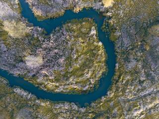 Autumn colors on the river Grabia, illuminated by the setting sun, Poland.