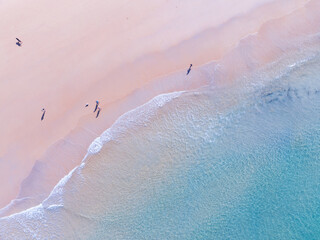 Top view of beach sea surface, Shot in the open sea from above,Amazing nature beach background, Turquoise Water surface waves reflecting the Sunlight