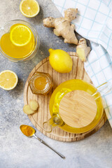 Healthy organic vegan drink. Antioxidant ginger turmeric lemon tea with honey on a stone table. Winter tea, Immunity boosting drink. View from above.