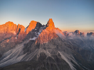 Pale di San Martino mountains during sunset. Aerial view. Rolle Pass, Trento Province, South Tyrol, Italy. - 551780744