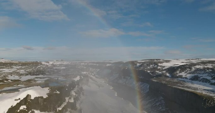 rainbow at Dettifoss waterfall with snow