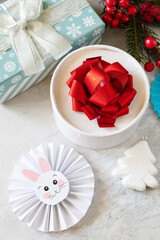 Winter greeting card. Christmas background with Christmas tree, gifts boxs and symbol of year lunar chinese calendar, year of the rabbit.