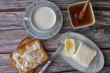 Clotted cream (butter cream) for Turkish breakfast - Kaymak, honey and glass of milk