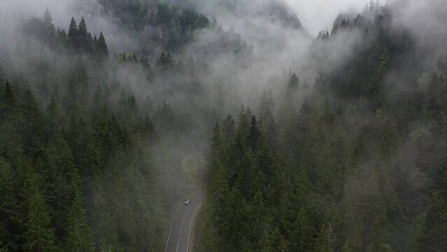 Bicaz pass mountain road high up in the Carpathian Mountains in Romania on a foggy autumn day