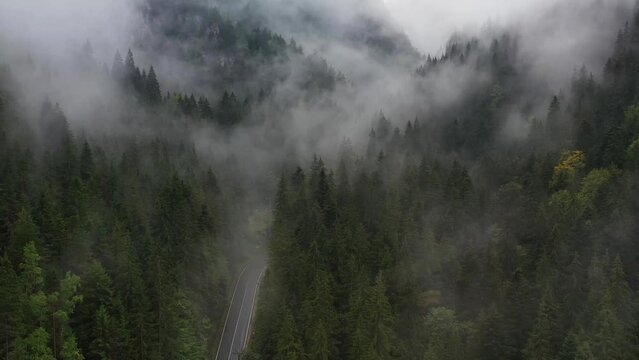 Bicaz pass mountain road high up in the Carpathian Mountains in Romania on a foggy autumn day
