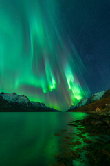 Fototapeta na wymiar Aurora reflected in the fjord, Kvaloya, Tromso, Norway