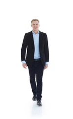 in full growth.a young man in a business suit striding forward .