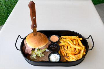 Big tasty burger with beef cutlet on a plate. Crispy chicken burger.