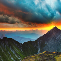 Majestic mountain peak with dramatic clouds and vibrant sunset