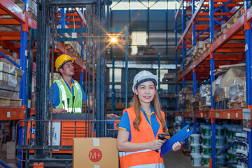 Portrait asian engineer in helmets order on tablet for checking goods and supplies on shelves with goods background in warehouse.logistic  business export ,Warehouse worker checking packages on store.