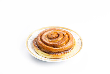 Obraz na płótnie Canvas A bun on a plate. On a white background. Cupcakes