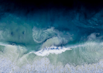 Fototapeta na wymiar Surfer at Trigg Beach Perth Western Australia in Stormy ocean waters