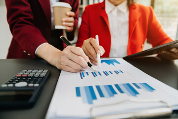 Businessman and team analyzing financial statement Finance task. with smart phone and laptop and  tablet. Wealth management concept.