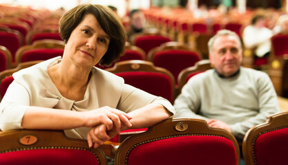 mature man and woman in theater watching a performance