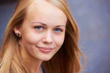 Beauty, happiness and portrait of woman with smile for wellness, positive mindset and relaxing. Youth, cosmetics and face of young teenager from Ireland with healthy skin, blonde hair and blue eyes