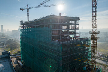 Construction site with a tower crane. Construction of residential buildings. Panoramic view of the construction of skyscrapers. Landscape with a modern city, Katowice. © Chawran