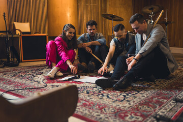 Music band members having a rehearsal with notes on the floor. High quality photo