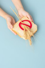 Hand holding Bread slice marked with gluten free