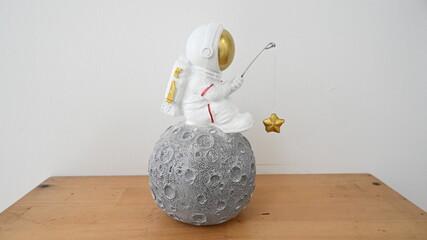 Plastic figurine of an astronaut in a spacesuit. Children's toy astronaut. Fascination with space, the study of planets. From beside © Spezia