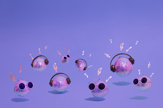 Shiny disco balls with headphones, sunglasses, musical notes and violin keys in vivid gradient neon colors. Concept of Christmas, New Year and winter holidays party, music and happiness. Good Vibes. - Powered by Adobe