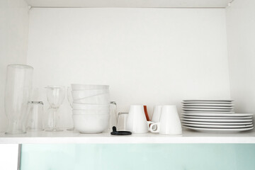 Fototapeta na wymiar A shelf with dishes in the kitchen cupboard