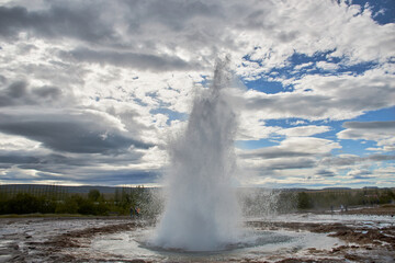 Strokkur fountain-type geyser erupting in geothermal area, southwest Iceland, Europe.