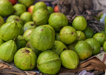 Close-up photo of guavas in market. Fruits background. Texture green guava.