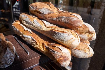 French bakery, many fresh baked baguettes breads ready for sale close up